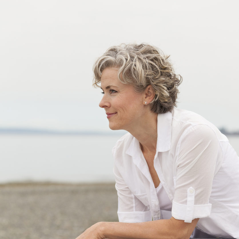 older woman smiling at the beach